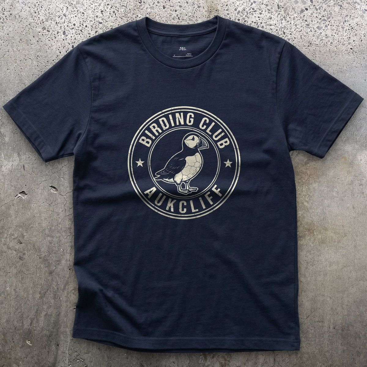 A Weathered Birding Club Crest With a Puffin design on a Navy Gildan Softstyle t-shirt