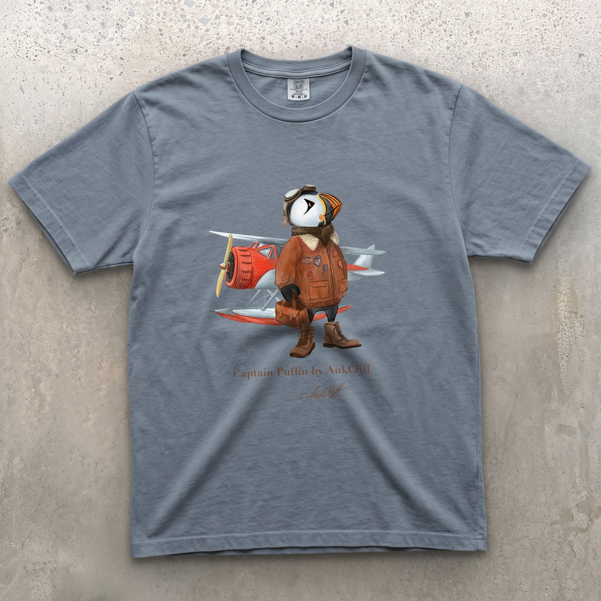 Captain Puffin Bush Pilot on a Blue Jean Comfort Colors t-shirt