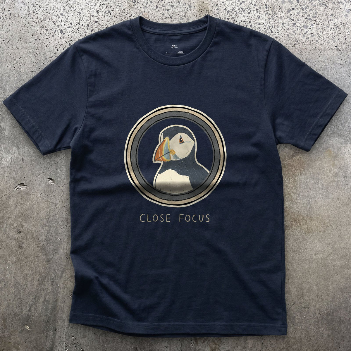 Close Focus on a Puffin design on a Navy Gildan Softstyle t-shirt