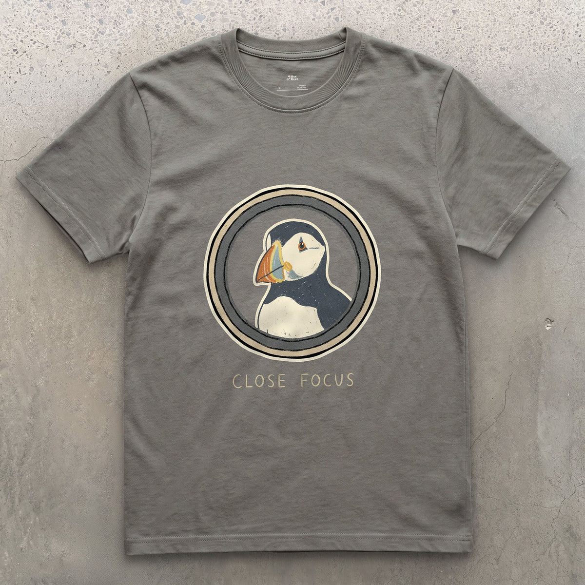 Close Focus on a Puffin design on a Charcoal Gildan Softstyle t-shirt