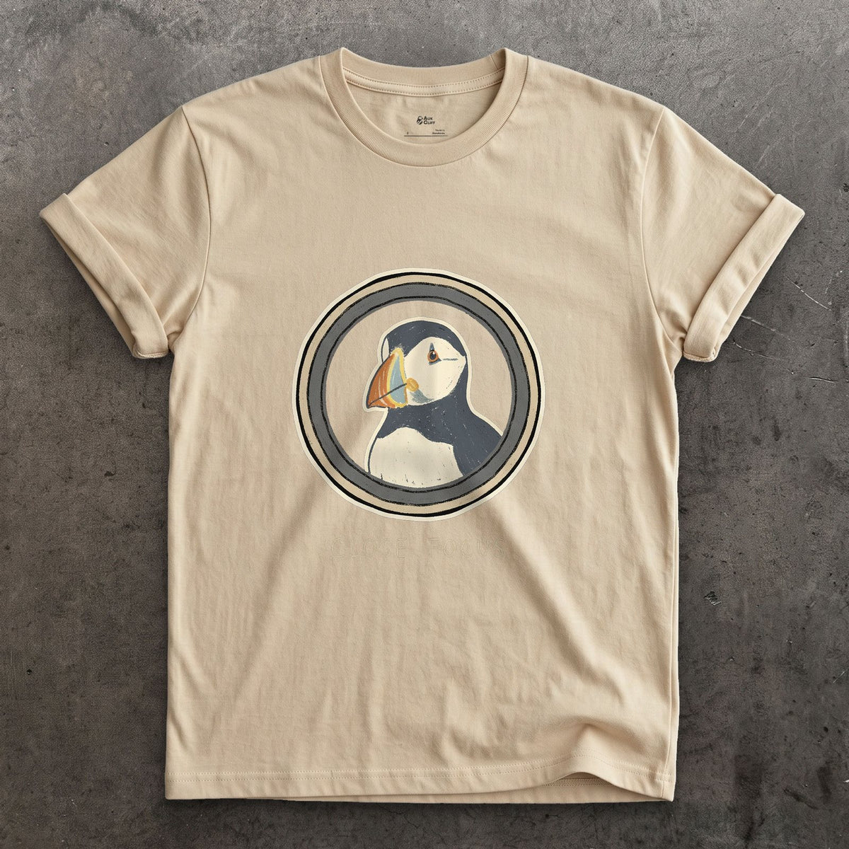 Close Focus on a Puffin design on a Sand Gildan Softstyle t-shirt
