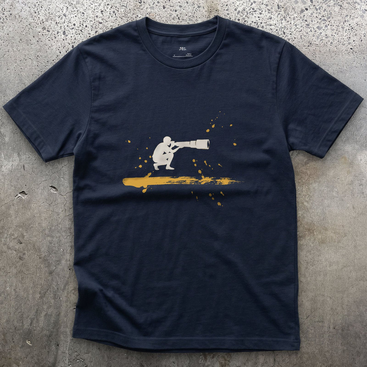 Crouched Behind the Lens design on a Navy Gildan Softstyle t-shirt