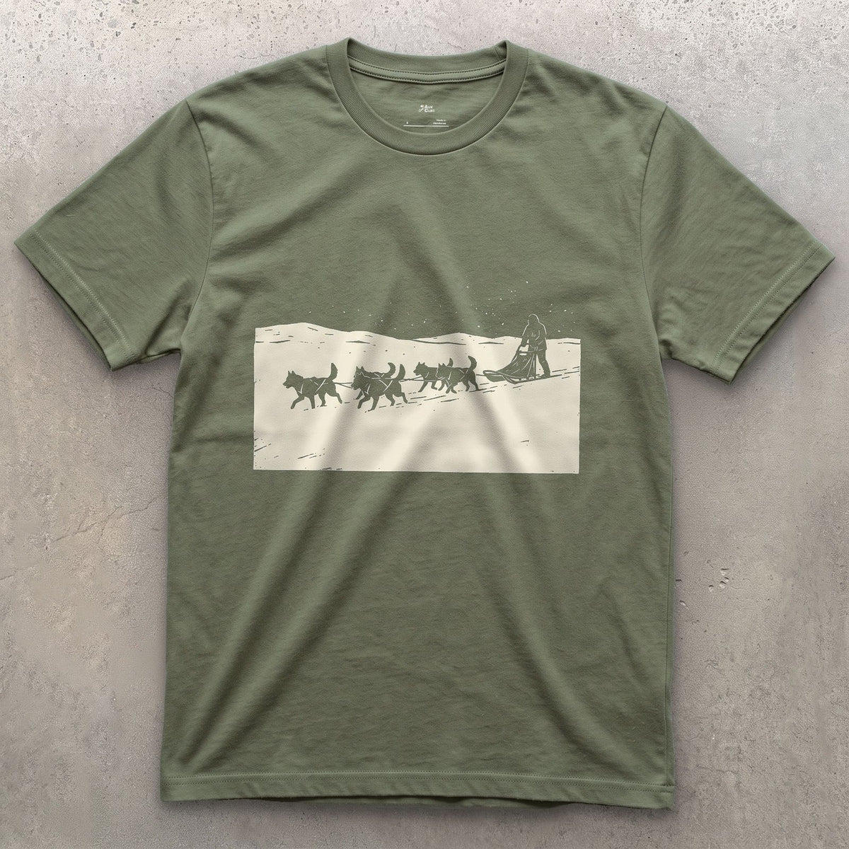 Dog Sled Team Running in Formation design on a Military Green Gildan Softstyle t-shirt