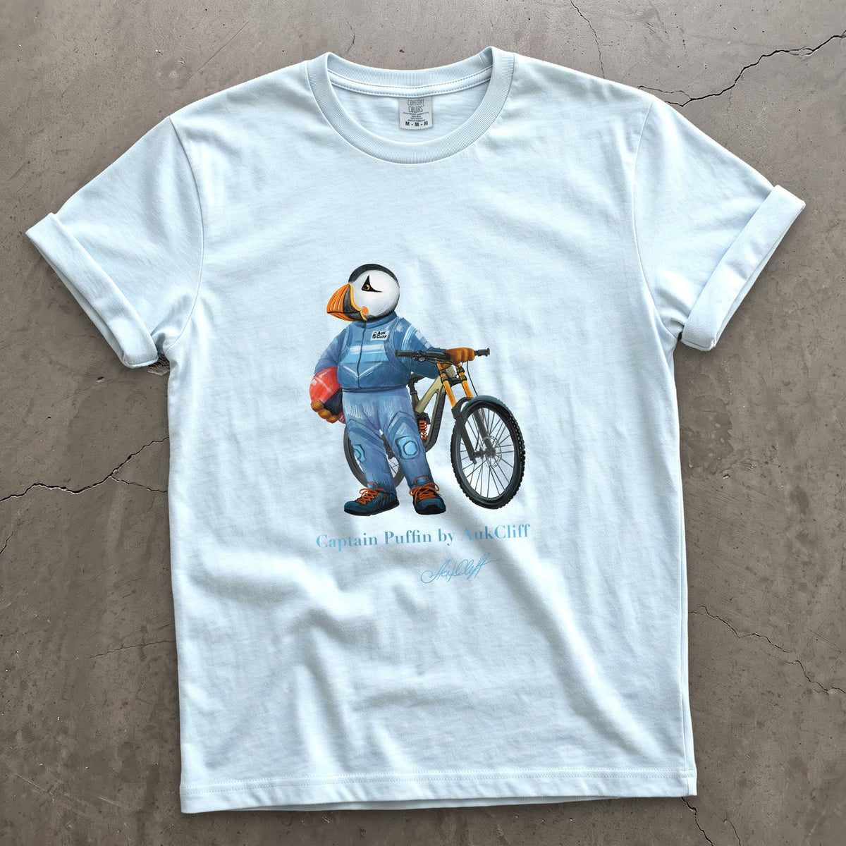 Captain Puffin Downhill Mountain Biker on a Chambray Comfort Colors t-shirt