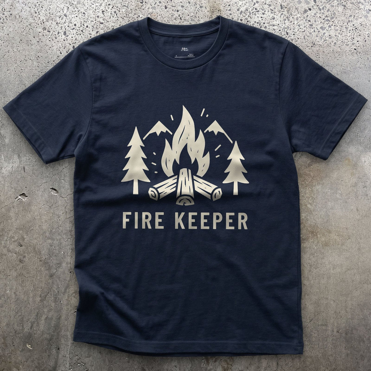 The Fire Keeper, Mountains and Firewood design on a Navy Gildan Softstyle t-shirt