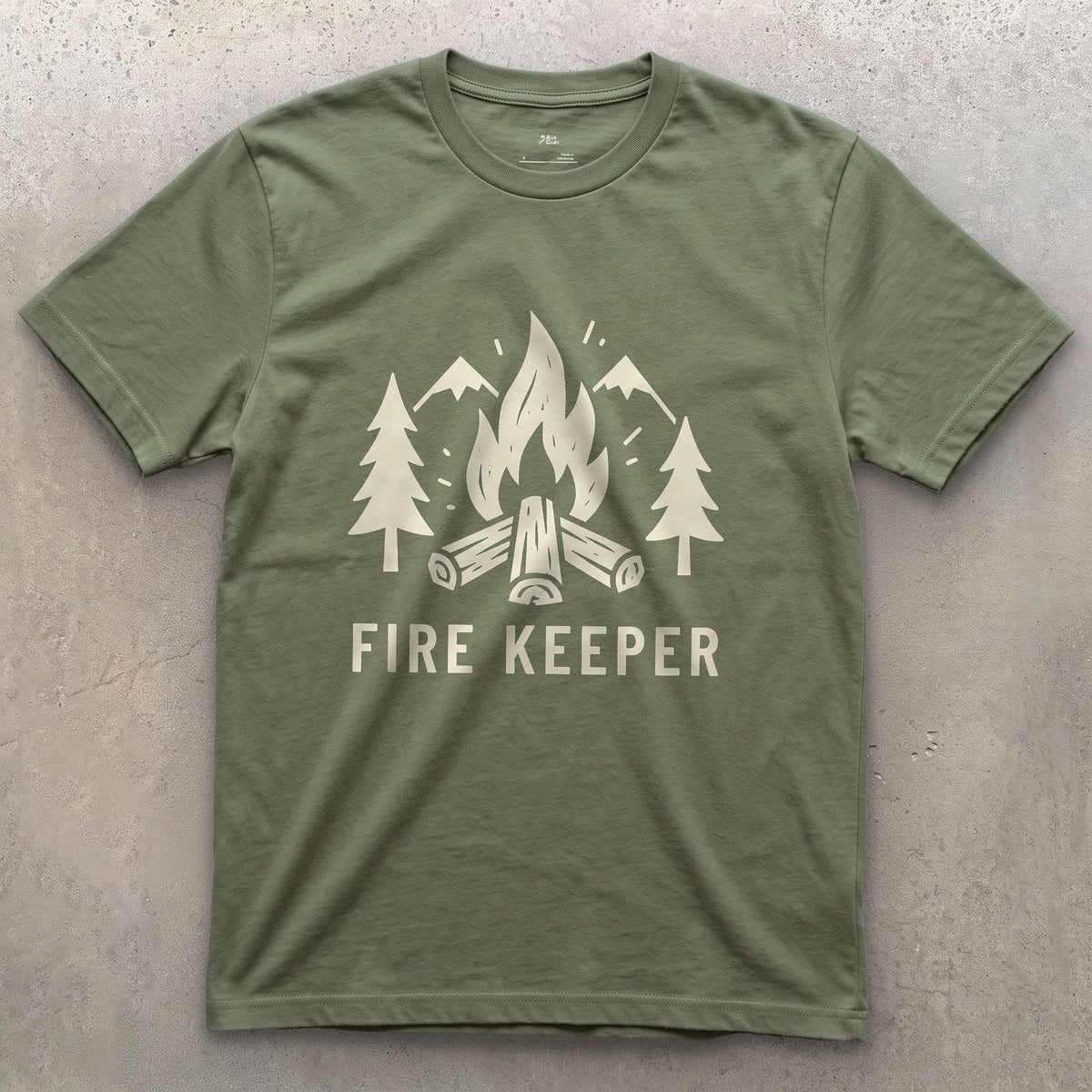 The Fire Keeper, Mountains and Firewood design on a Military Green Gildan Softstyle t-shirt