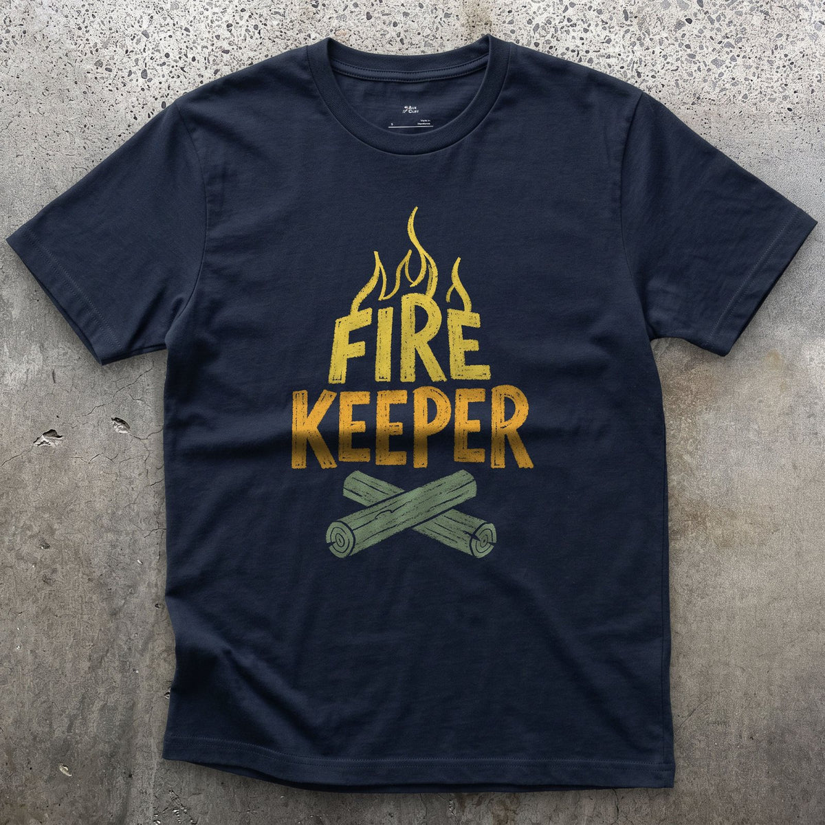 Fire Keeper, Crossed Logs at Camp design on a Navy Gildan Softstyle t-shirt