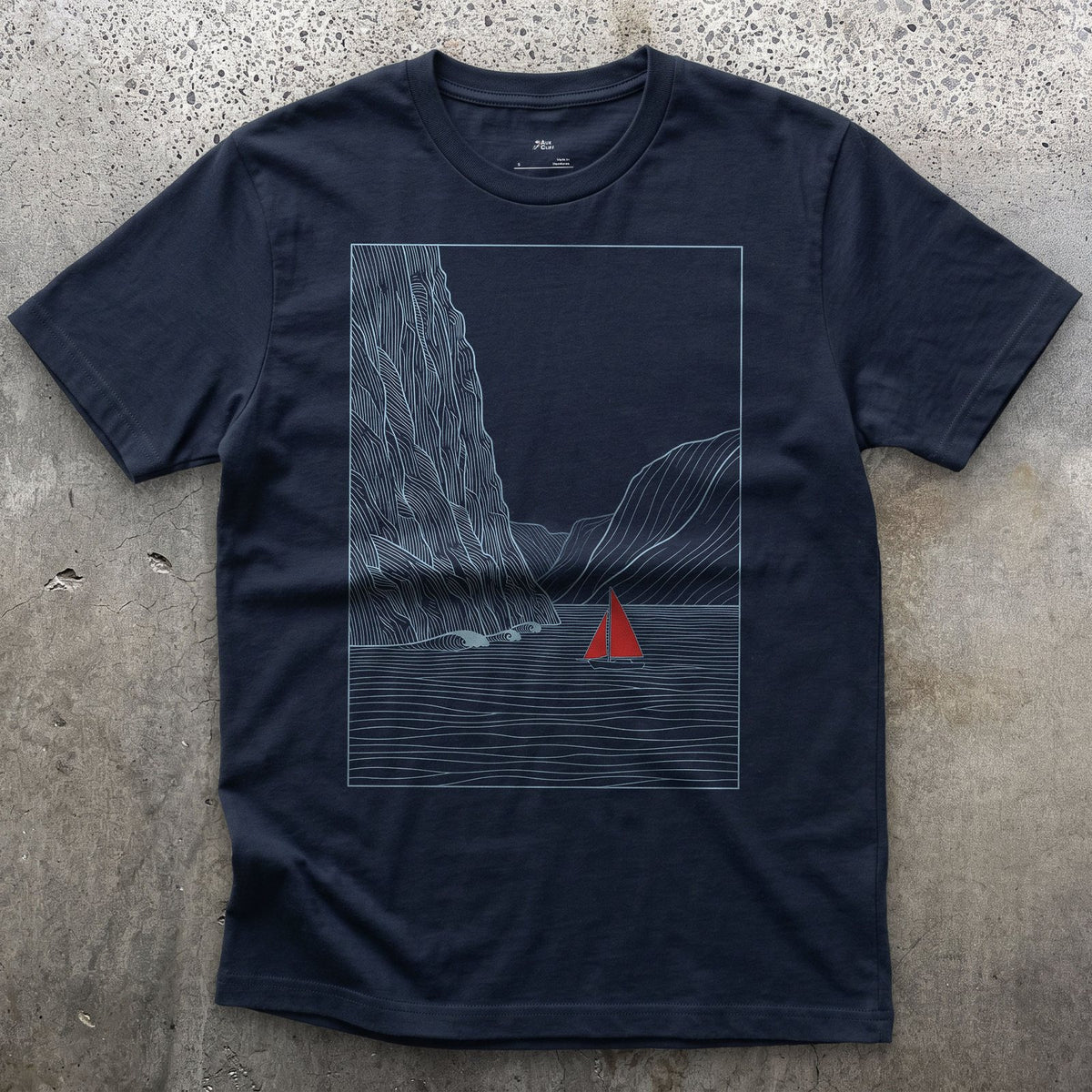 Small Against the Mountain Fjord, Red Sailboat design on a Navy Gildan Softstyle t-shirt