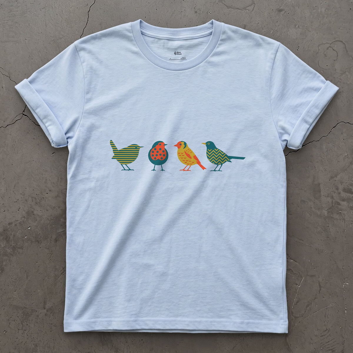 Four Birds in a Row, Each in Its Own Pattern design on a Light Blue Gildan Softstyle t-shirt