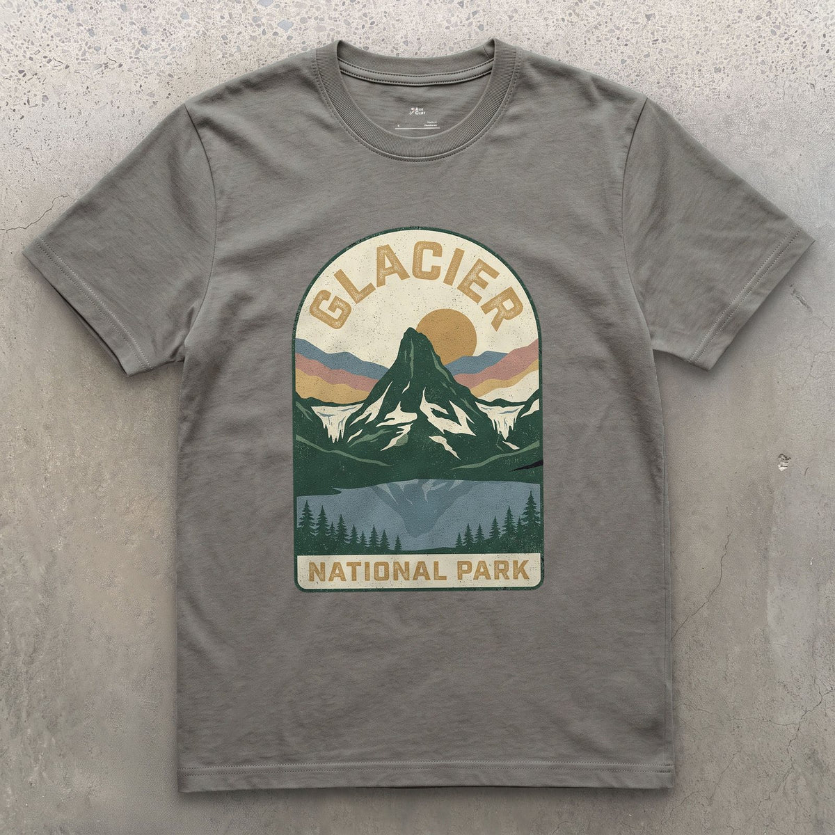 Glacier National Park Badge design on a Charcoal Gildan Softstyle t-shirt