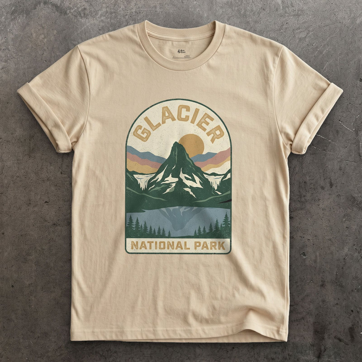 Glacier National Park Badge design on a Sand Gildan Softstyle t-shirt