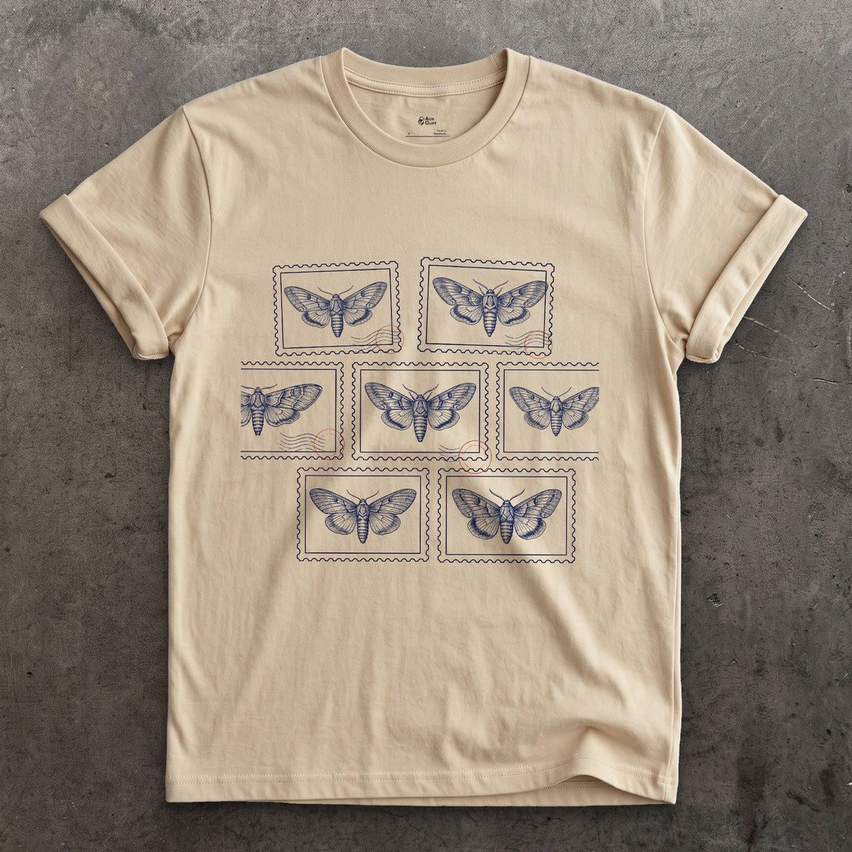 Seven Wild Moths, None of Them Named design on a Sand Gildan Softstyle t-shirt