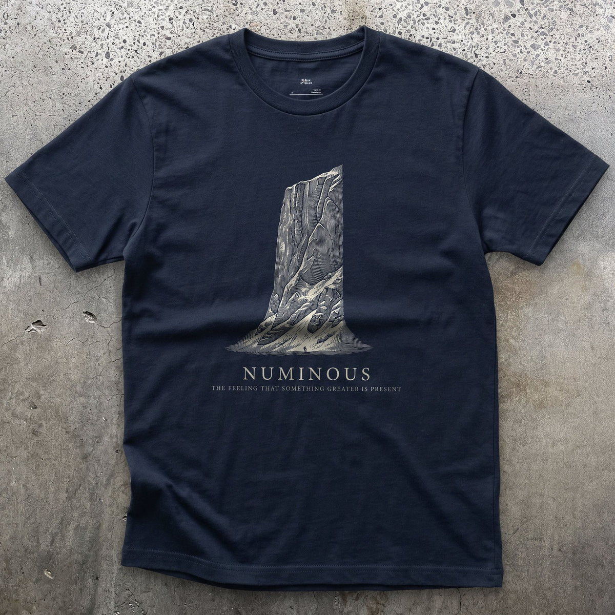 Numinous, the Feeling That Something Greater is Present design on a Navy Gildan Softstyle t-shirt