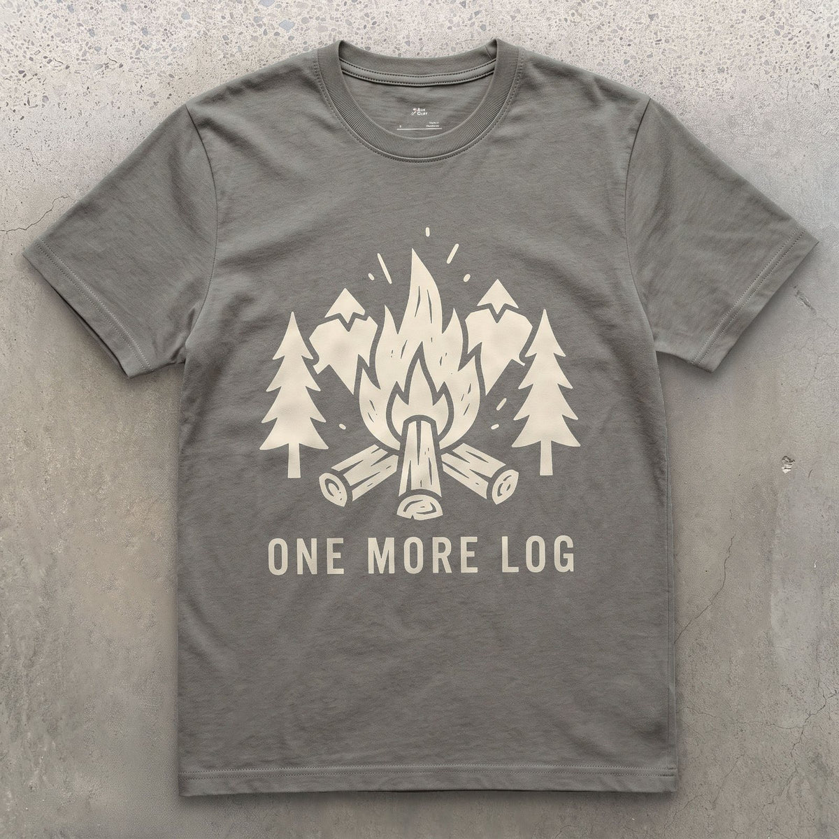 One More Log, Mountains and Firewood design on a Charcoal Gildan Softstyle t-shirt