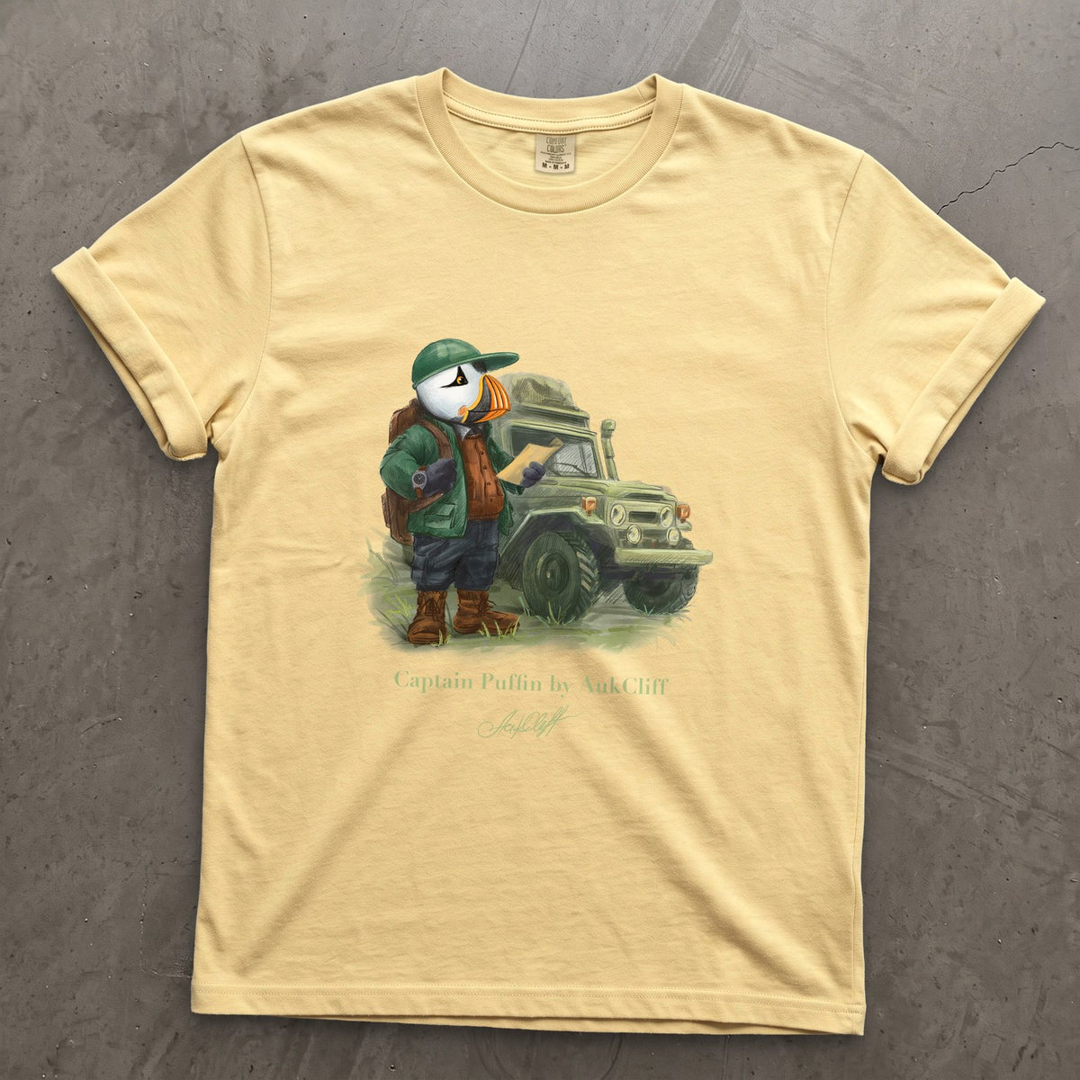 Captain Puffin Overland Explorer on a Butter Comfort Colors t-shirt