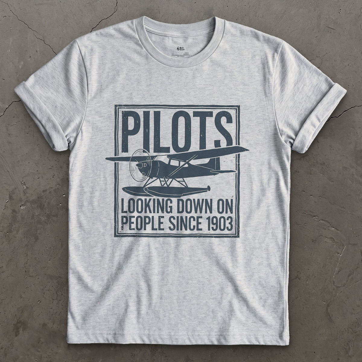 Pilots Looking Down Since 1903 design on a Sport Grey Gildan Softstyle t-shirt