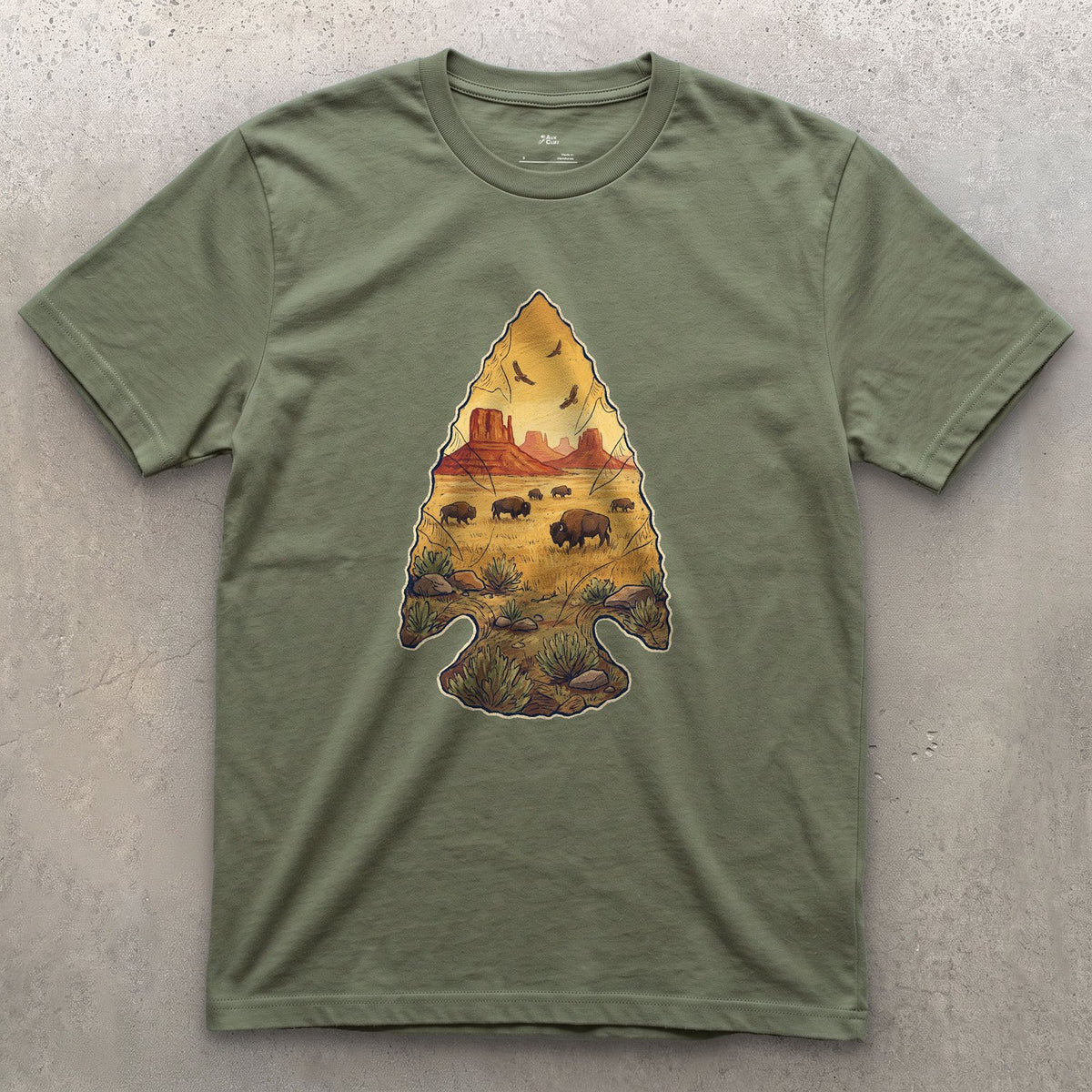 Plains Held in a Stone Arrowhead design on a Military Green Gildan Softstyle t-shirt