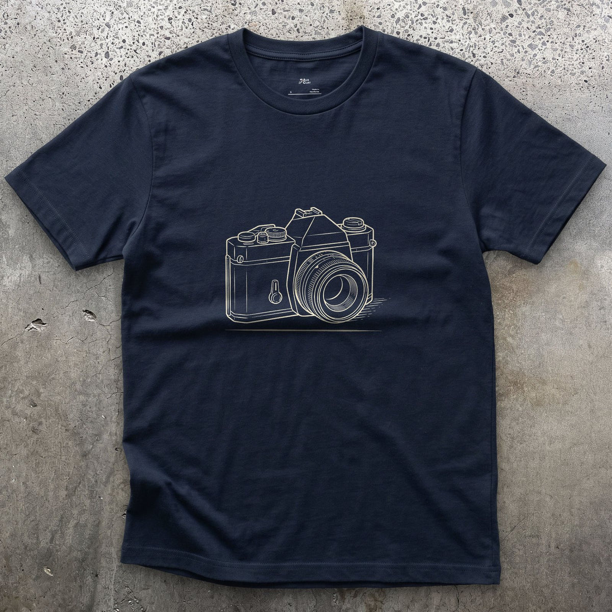 Still the Camera Shape Everyone Pictures First design on a Navy Gildan Softstyle t-shirt