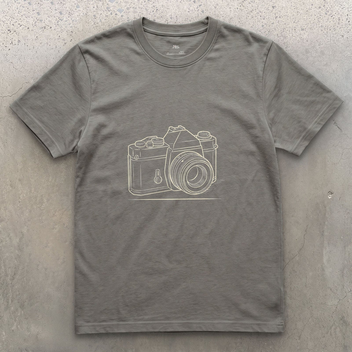 Still the Camera Shape Everyone Pictures First design on a Charcoal Gildan Softstyle t-shirt