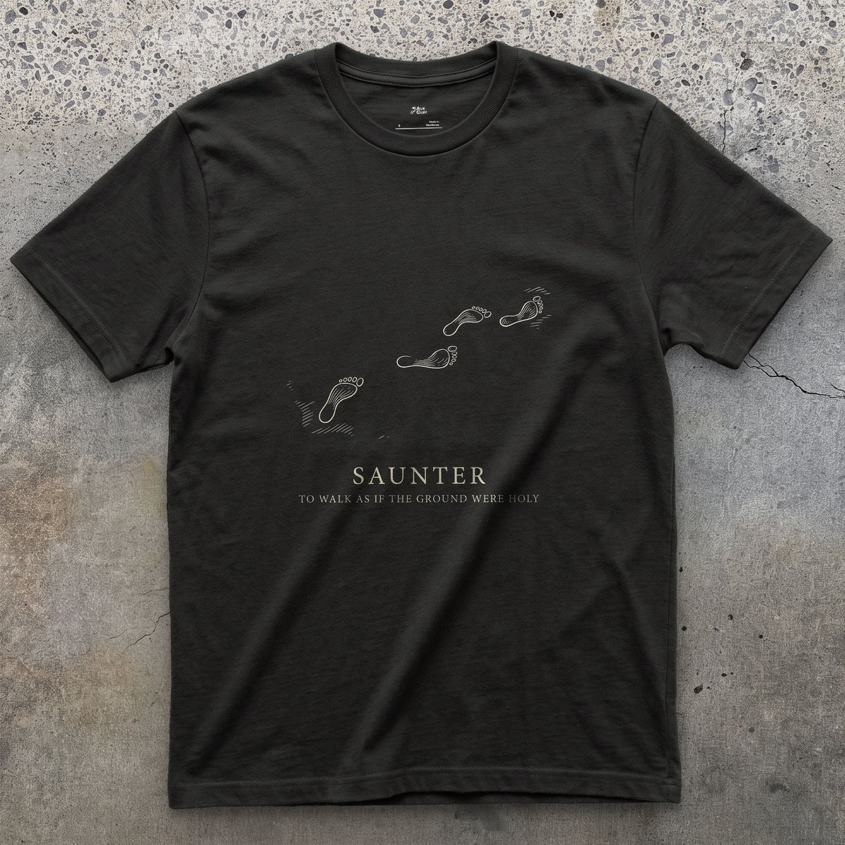 Saunter, to Walk As If the Ground Were Holy design on a Black Gildan Softstyle t-shirt