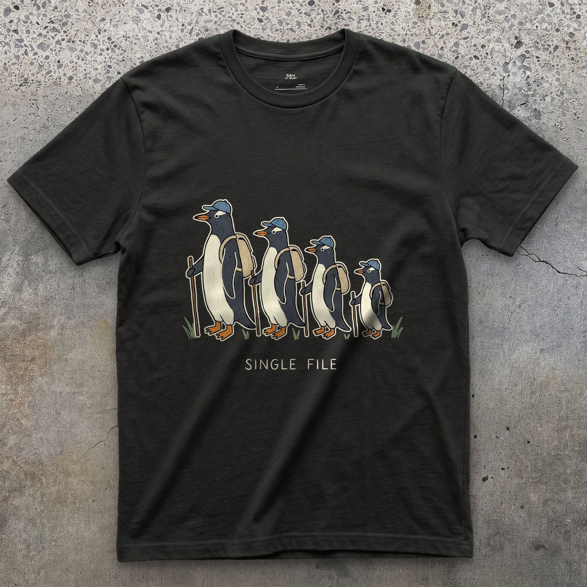 Single File, Penguins in the Same Track design on a Black Gildan Softstyle t-shirt