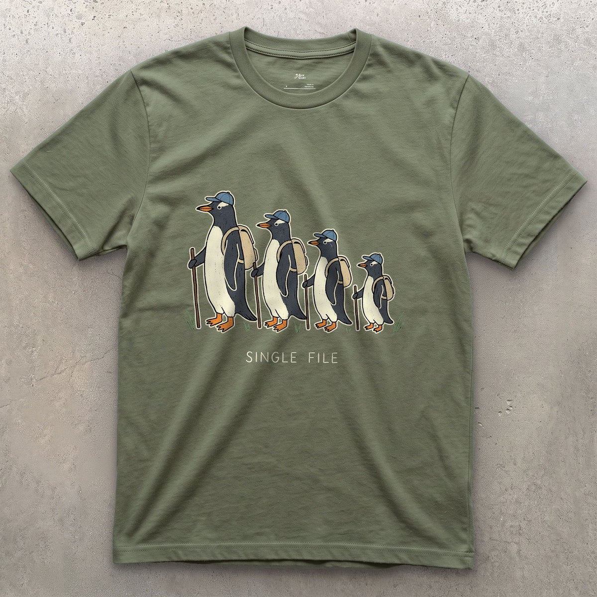 Single File, Penguins in the Same Track design on a Military Green Gildan Softstyle t-shirt