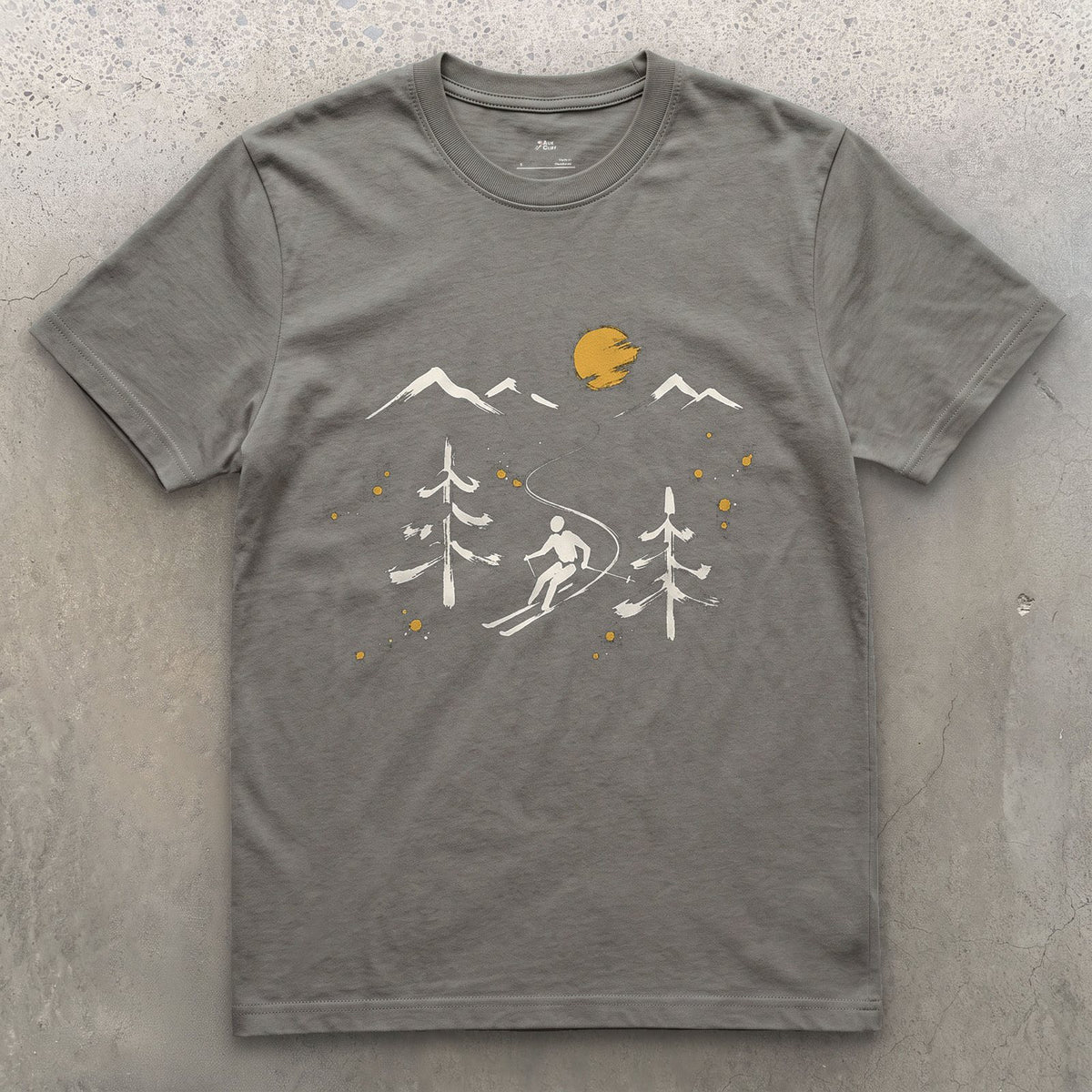 Pines and Peaks Ski design on a Charcoal Gildan Softstyle t-shirt
