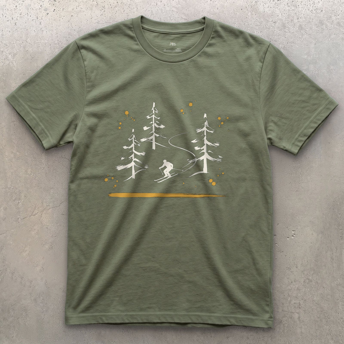 Skier Through the Pines design on a Military Green Gildan Softstyle t-shirt