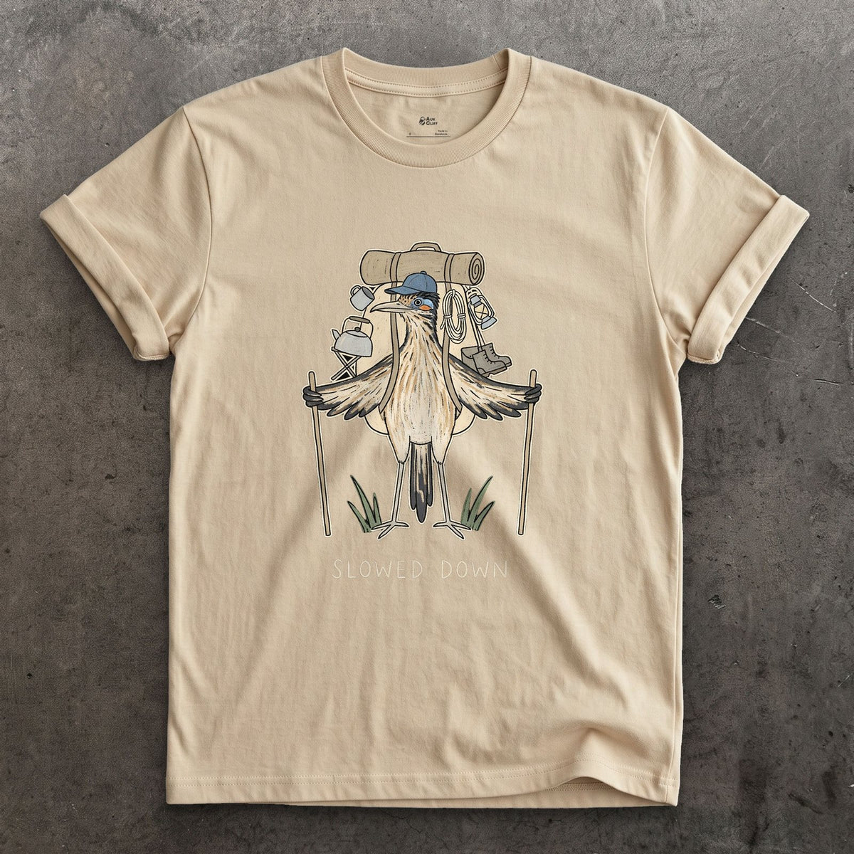 Slowed Down, Roadrunner Hiker design on a Sand Gildan Softstyle t-shirt