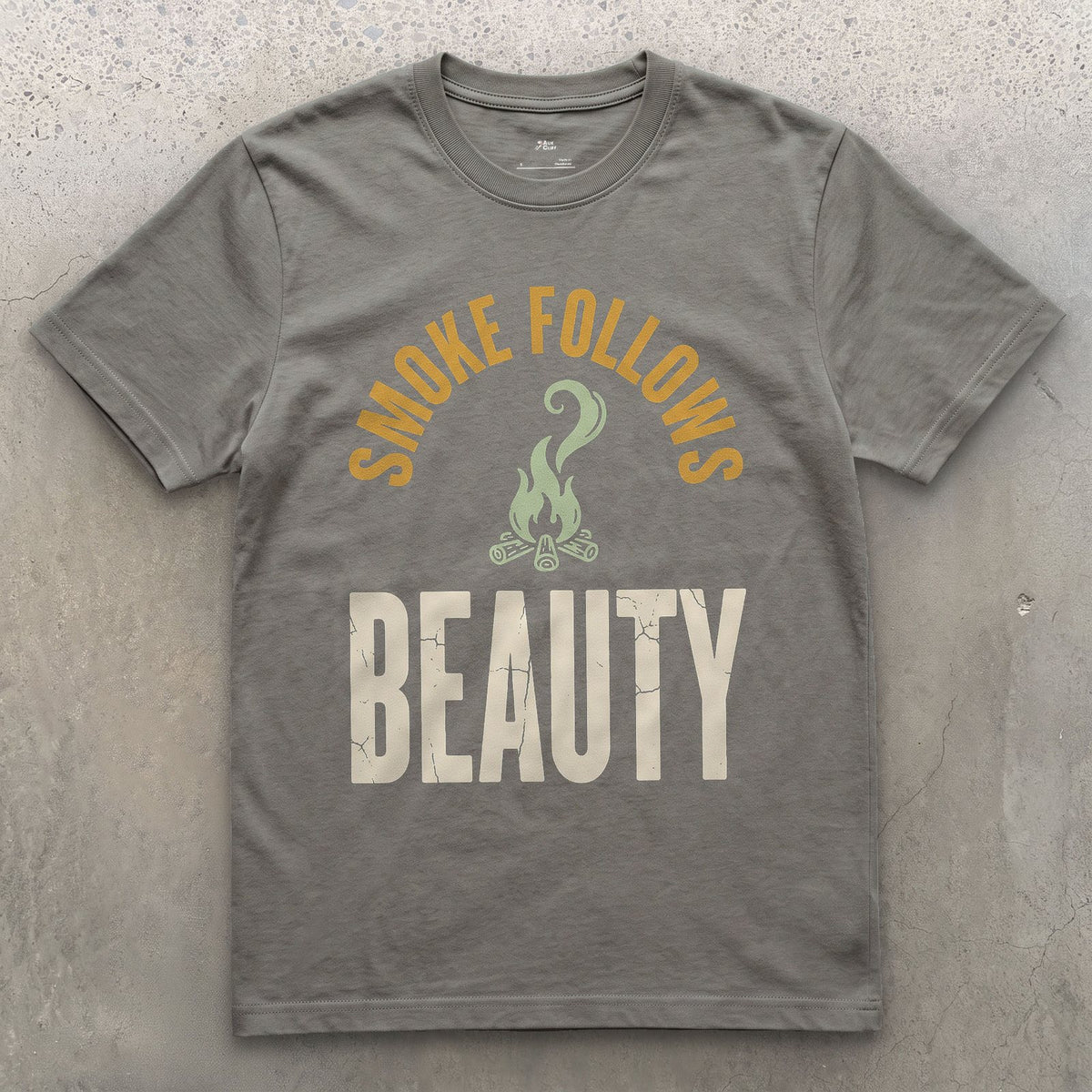 Smoke Follows Beauty, Rising Smoke Badge design on a Charcoal Gildan Softstyle t-shirt