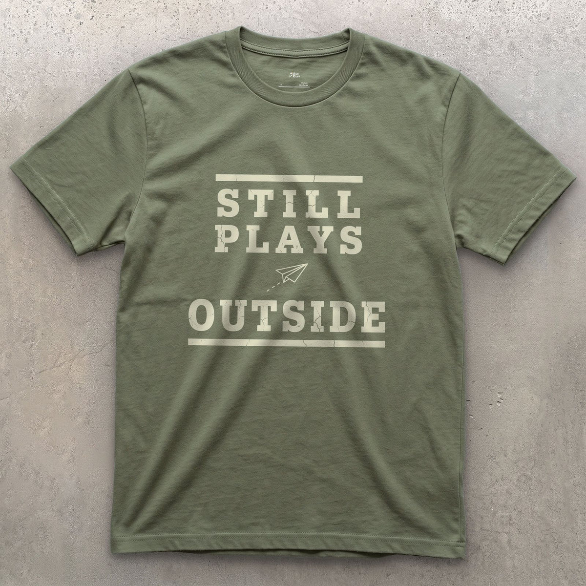 Still Plays Outside, Paper Airplane and All design on a Military Green Gildan Softstyle t-shirt