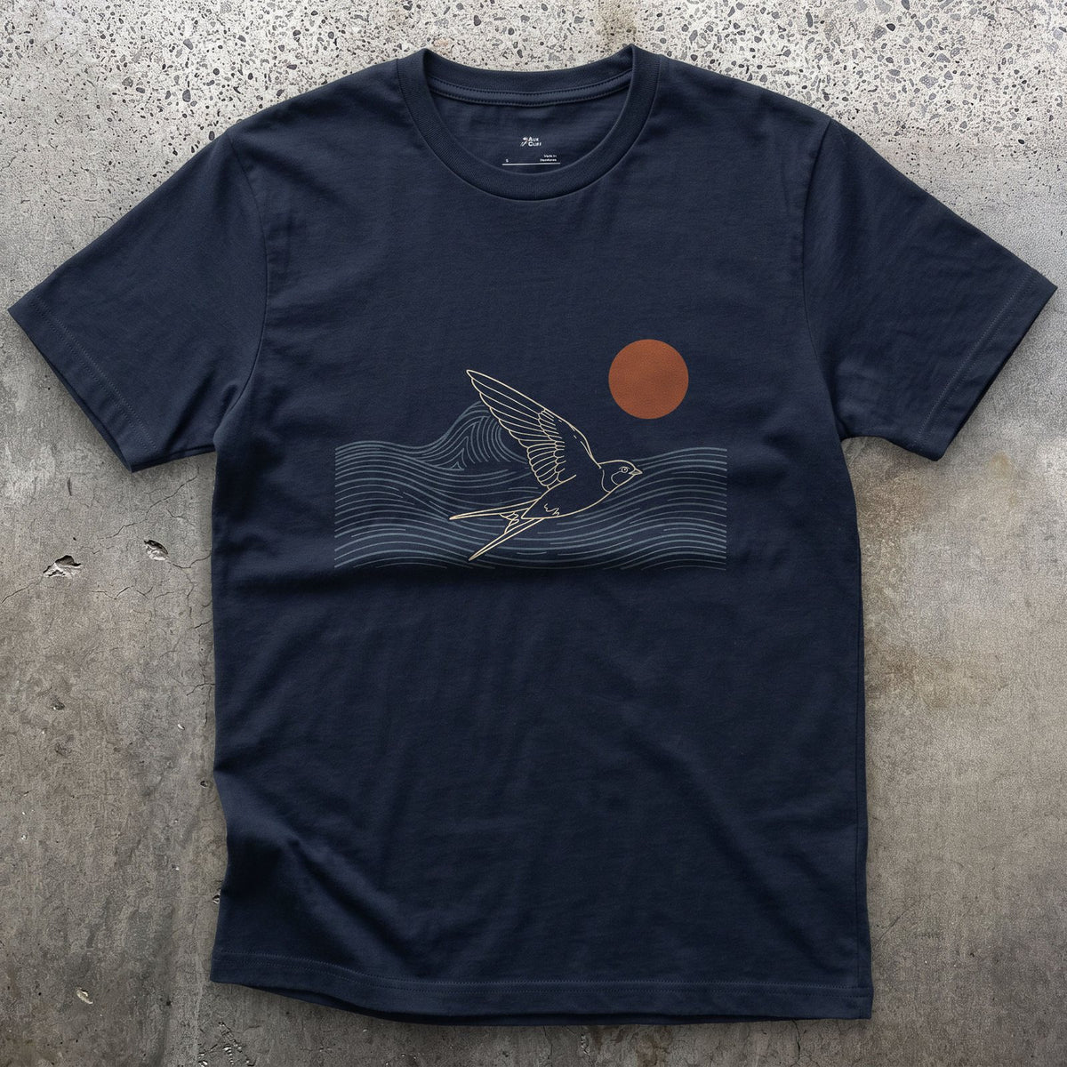 A Few Clean Lines, Swallow Above the Waves design on a Navy Gildan Softstyle t-shirt