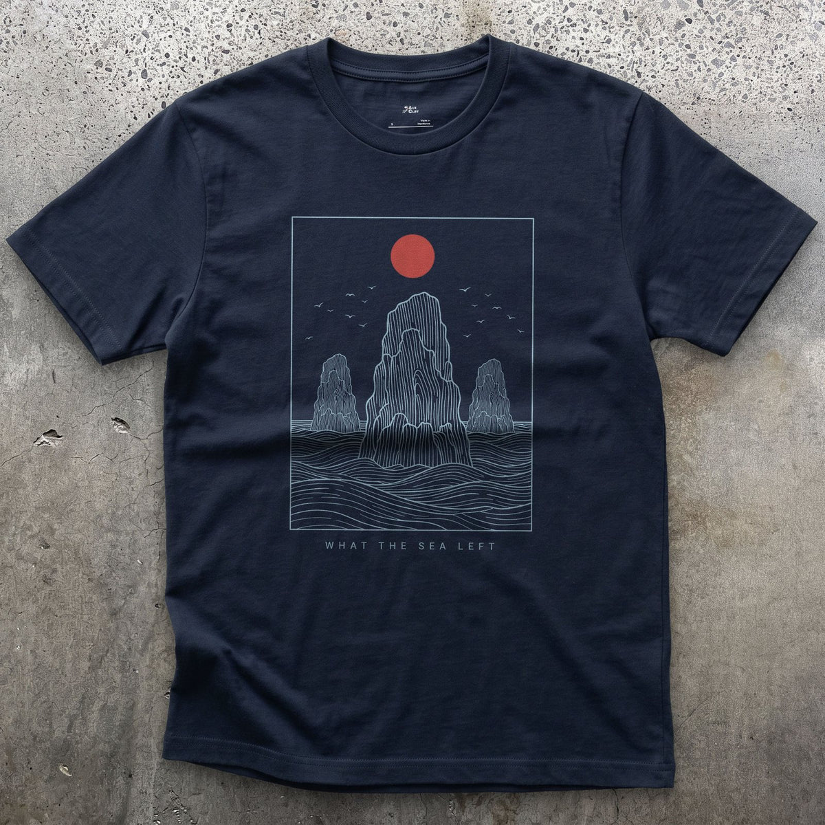 What the Sea Left, Stacks and Birds design on a Navy Gildan Softstyle t-shirt