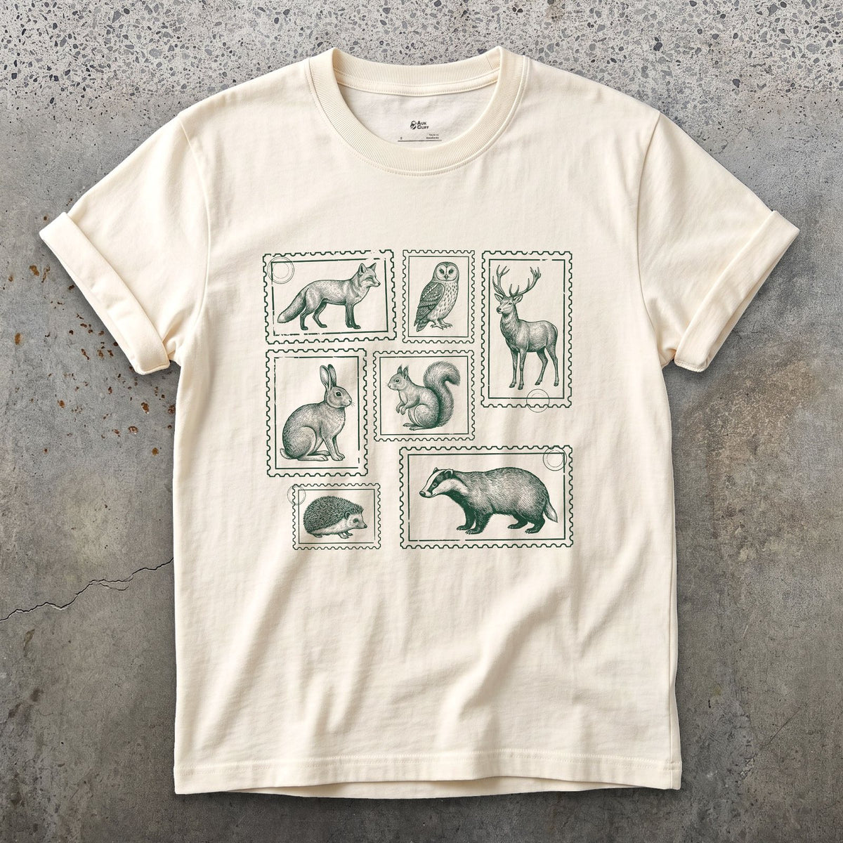 The Whole Woodland Framed Like Stamps design on a Natural Gildan Softstyle t-shirt