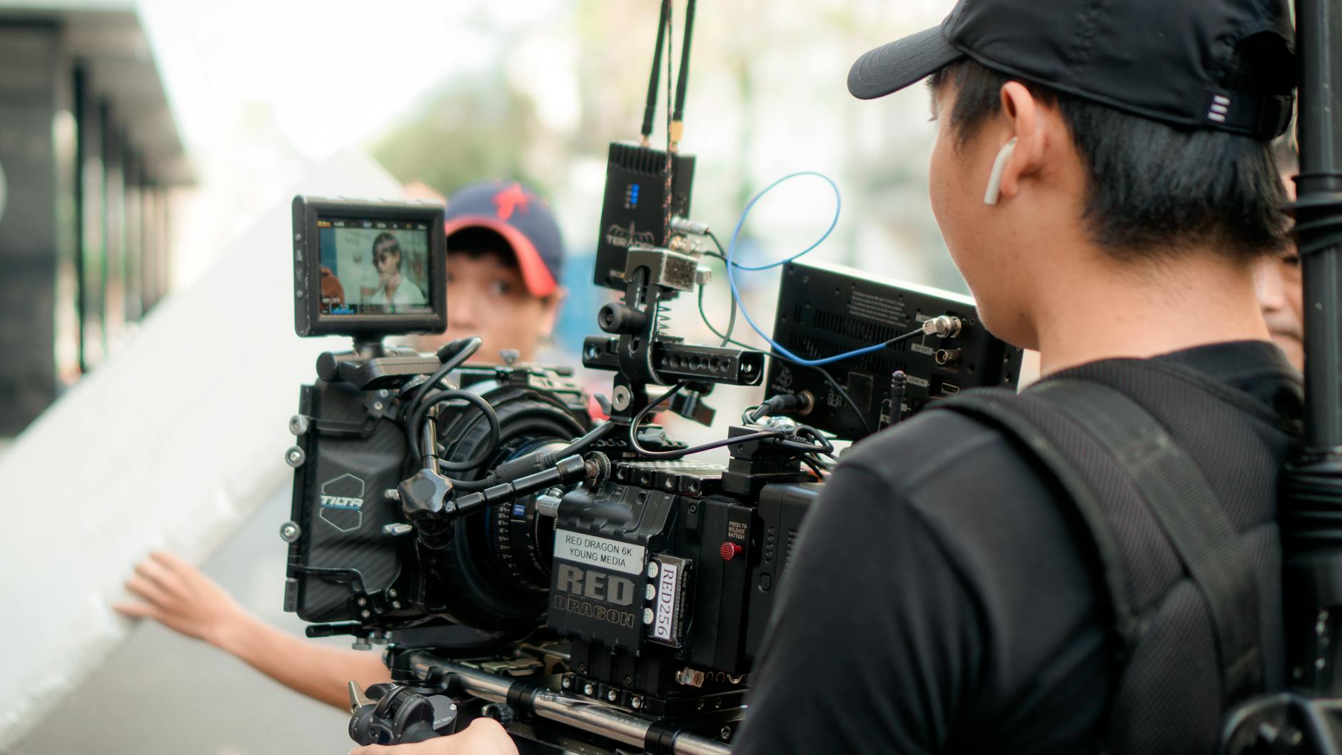 Documentary film crew working on a mountain location with a tripod-mounted camera