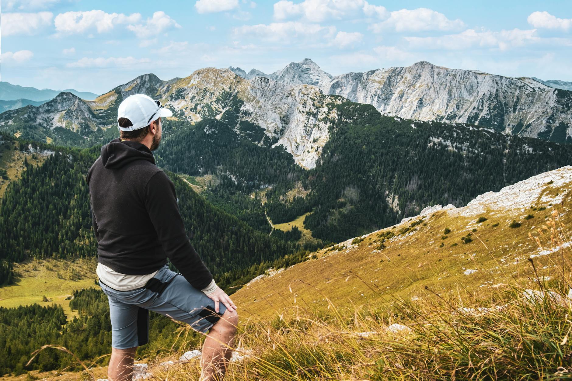 Hiker enjoying a scenic mountain view with a pack on their back