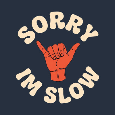 A shaka hand sign inside the words Sorry I'm Slow, printed on a navy cotton tee