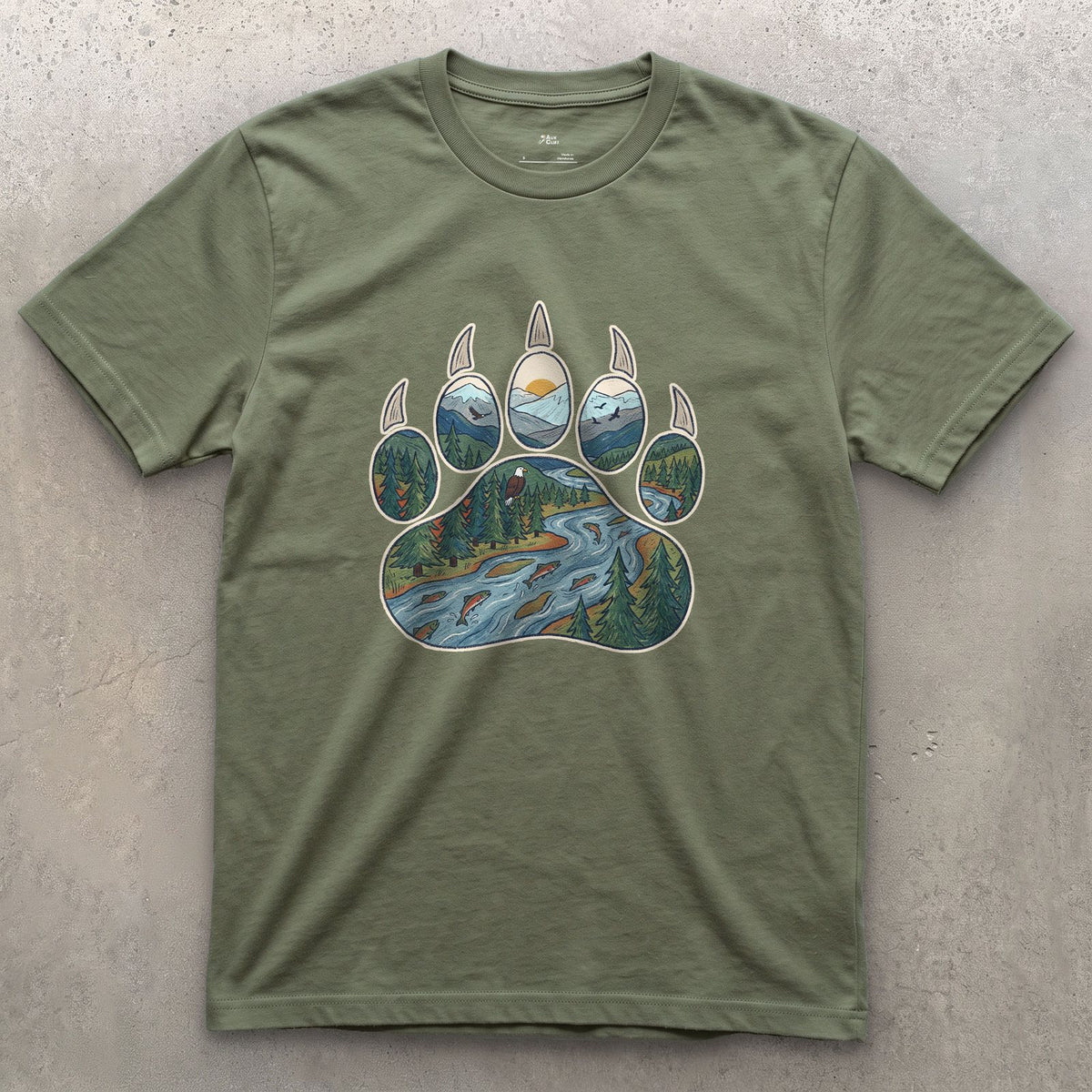A Salmon River in the Paw Print design on a Military Green Gildan Softstyle t-shirt
