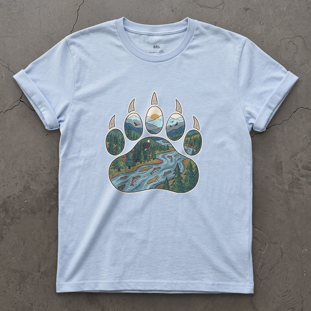 A Salmon River in the Paw Print design on a Light Blue Gildan Softstyle t-shirt