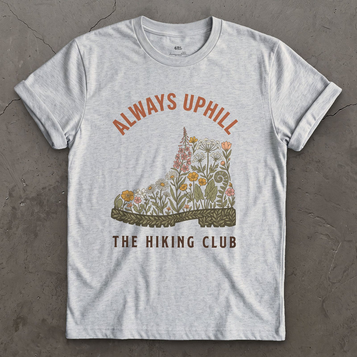 Always Uphill, Boot Full of Wildflowers design on a Sport Grey Gildan Softstyle t-shirt