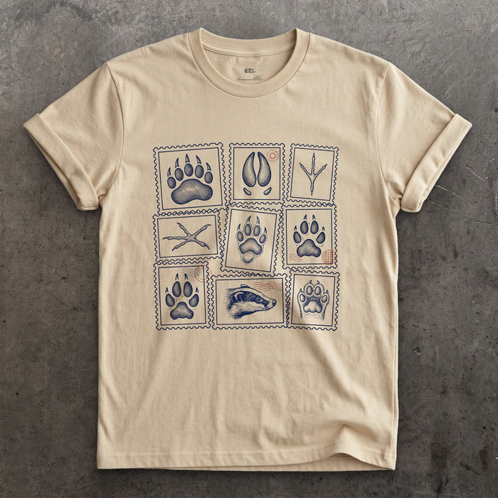 Four Signs Read Off the Trail design on a Sand Gildan Softstyle t-shirt