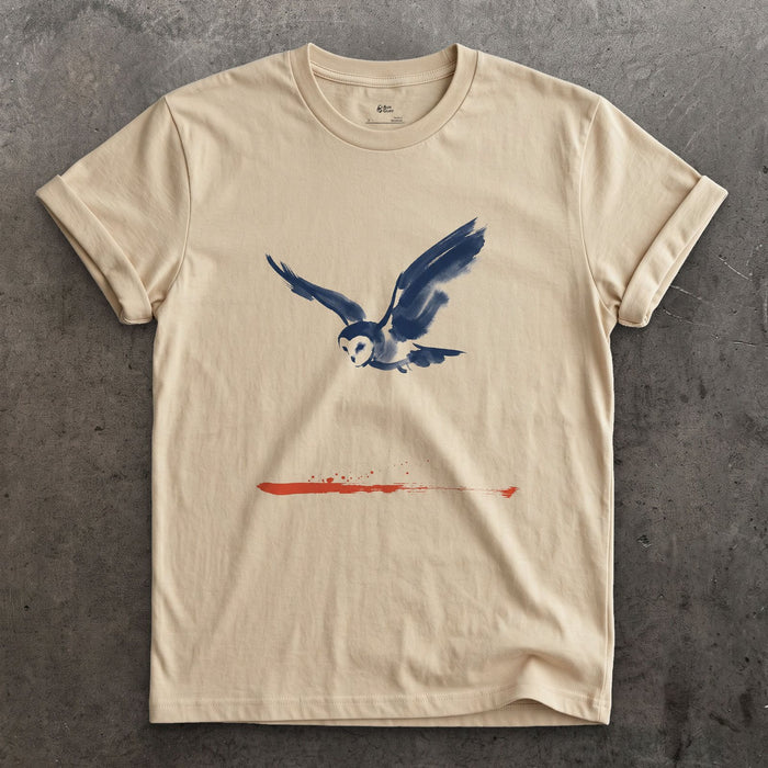 Owl in Flight Above a Red Horizon design on a Sand Gildan Softstyle t-shirt