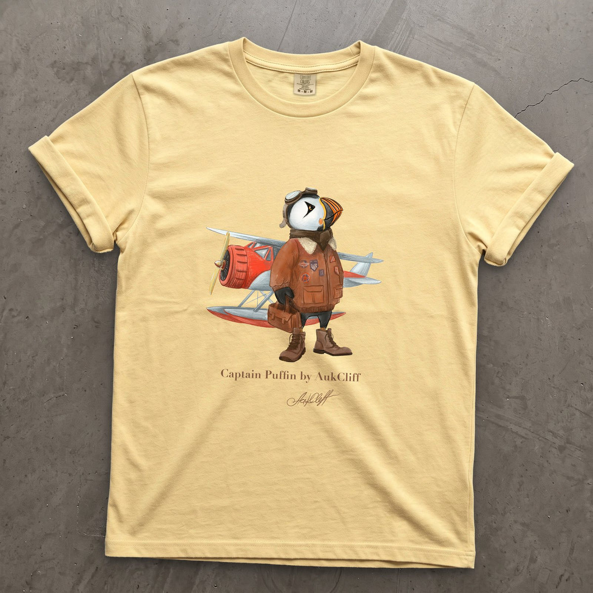 Captain Puffin Bush Pilot on a Butter Comfort Colors t-shirt