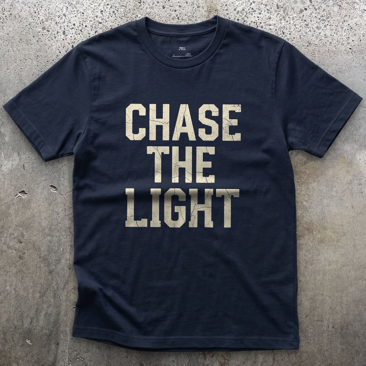 Chase the Light, Every Photographer Does design on a Navy Gildan Softstyle t-shirt