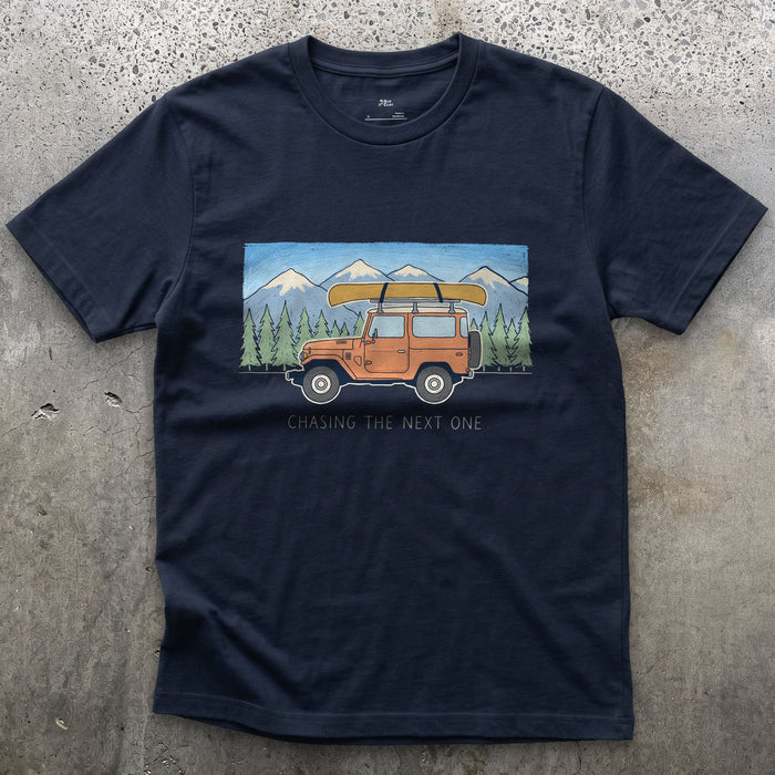 Chasing the Next One, Wagon With Canoe in Tow design on a Navy Gildan Softstyle t-shirt