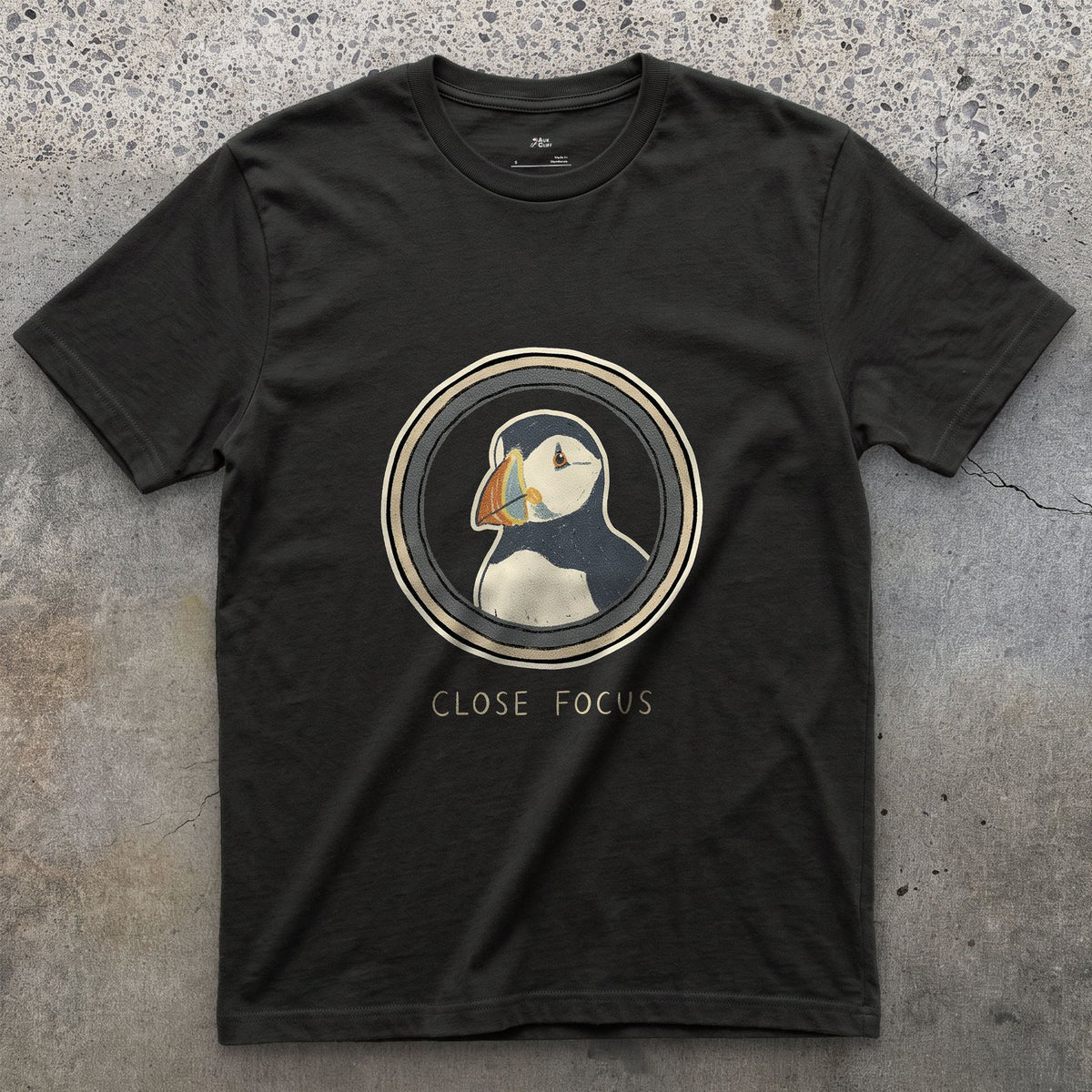 Close Focus on a Puffin design on a Black Gildan Softstyle t-shirt