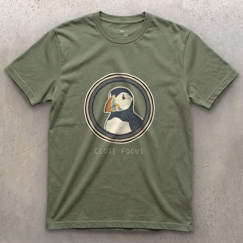 Close Focus on a Puffin design on a Military Green Gildan Softstyle t-shirt
