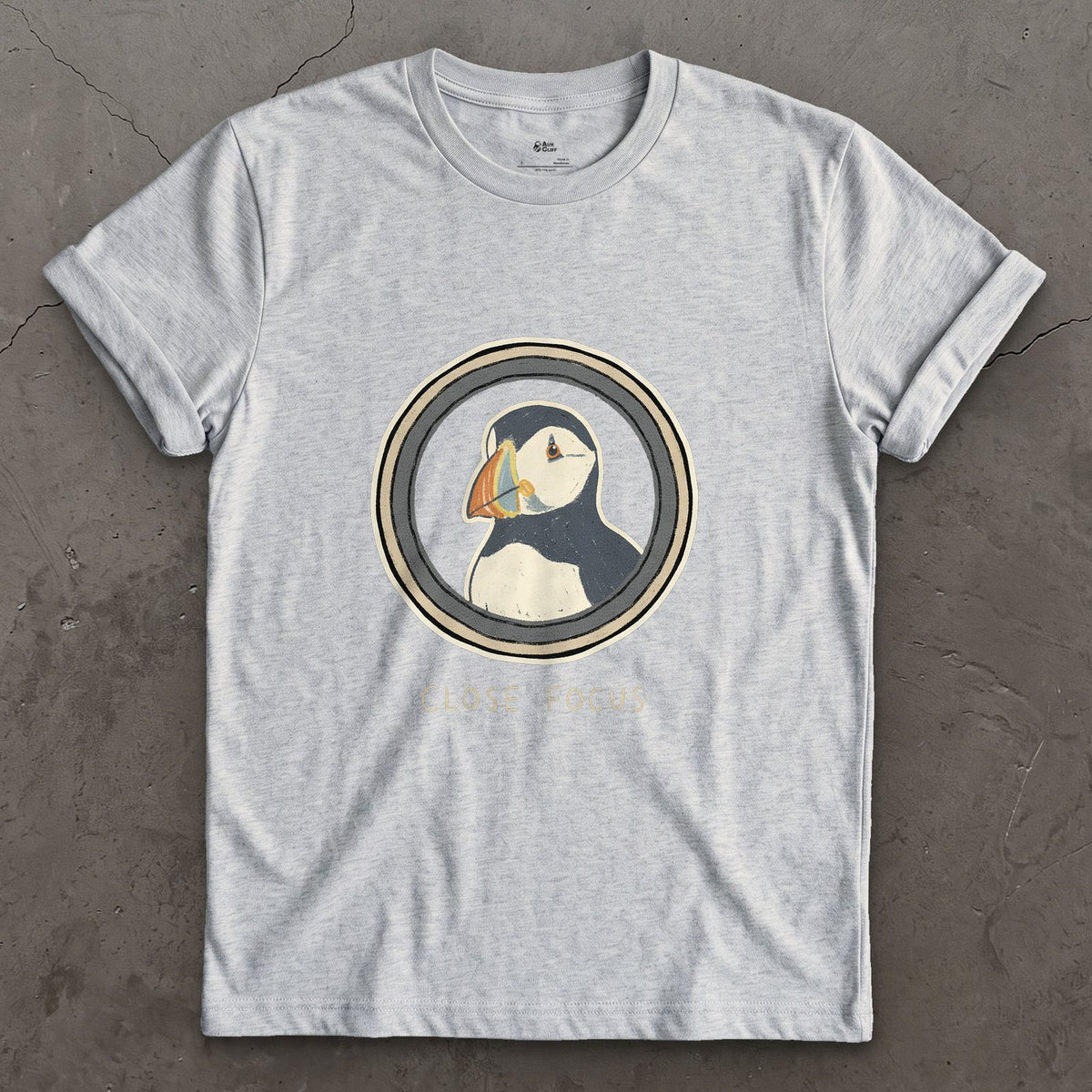 Close Focus on a Puffin design on a Sport Grey Gildan Softstyle t-shirt