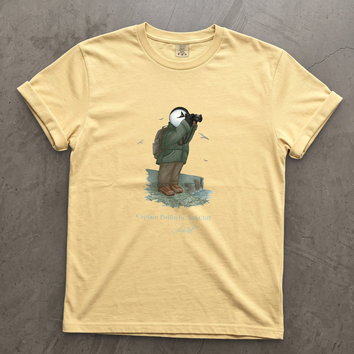 Captain Puffin Coastal Birder on a Butter Comfort Colors t-shirt