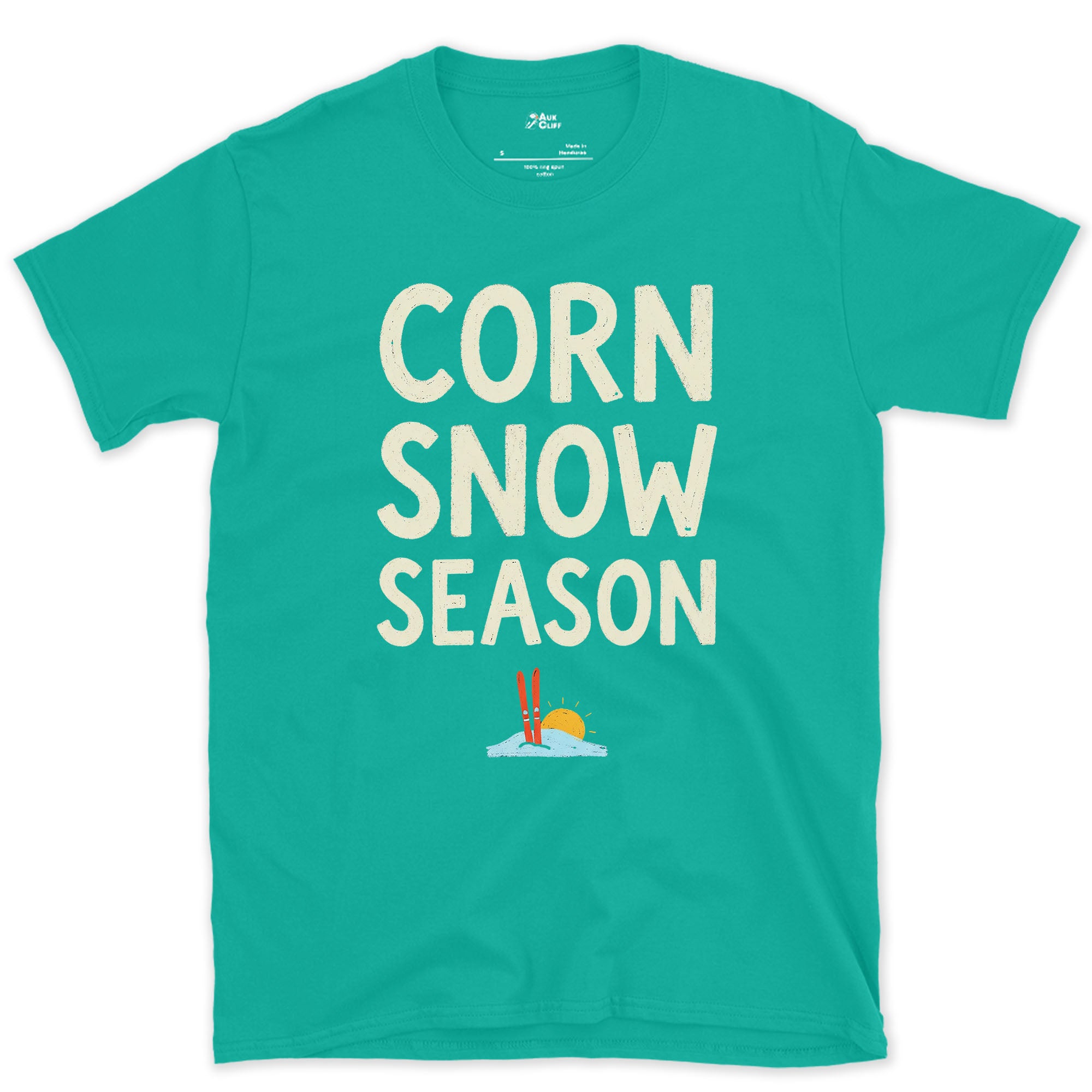 Corn Snow Season, Skis Under a Low Sun design on a Jade Dome Gildan Softstyle t-shirt